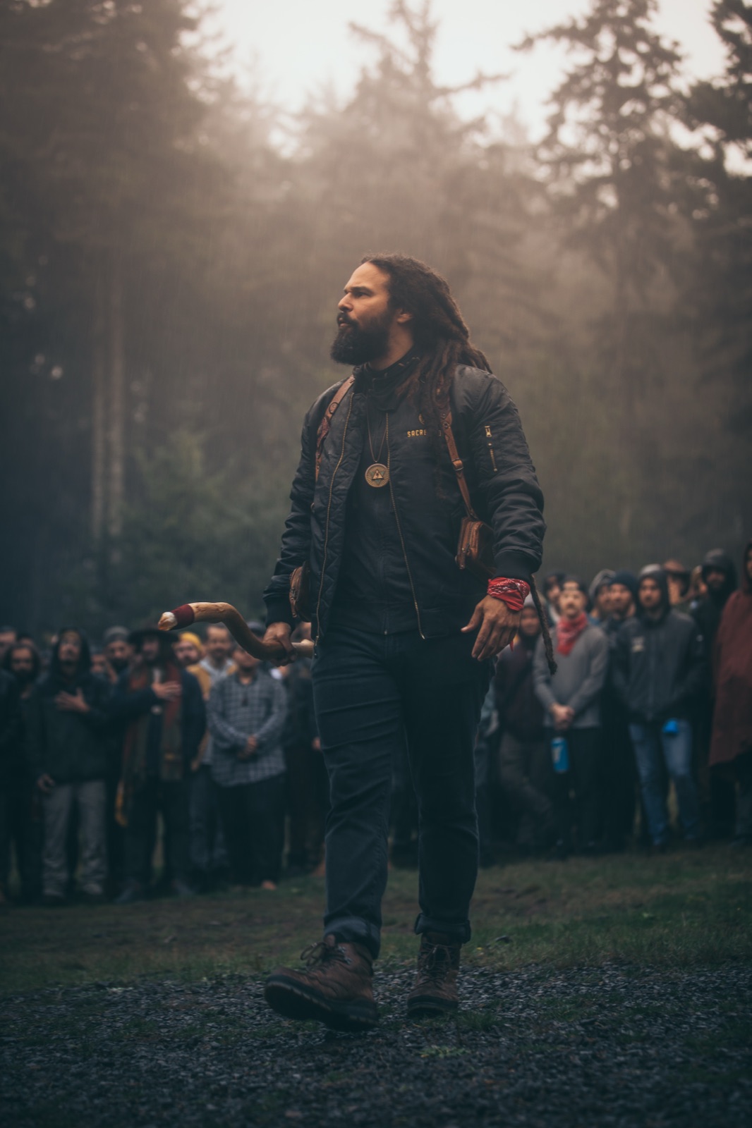 Adam Jackson standing before a circle of men
